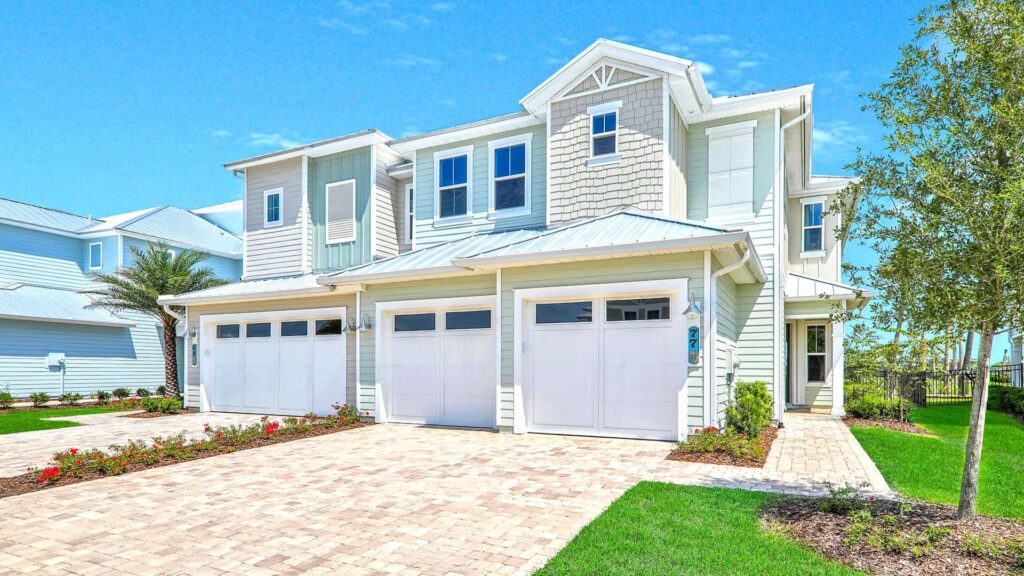 Beachwalk townhome with brick front driveway and garden