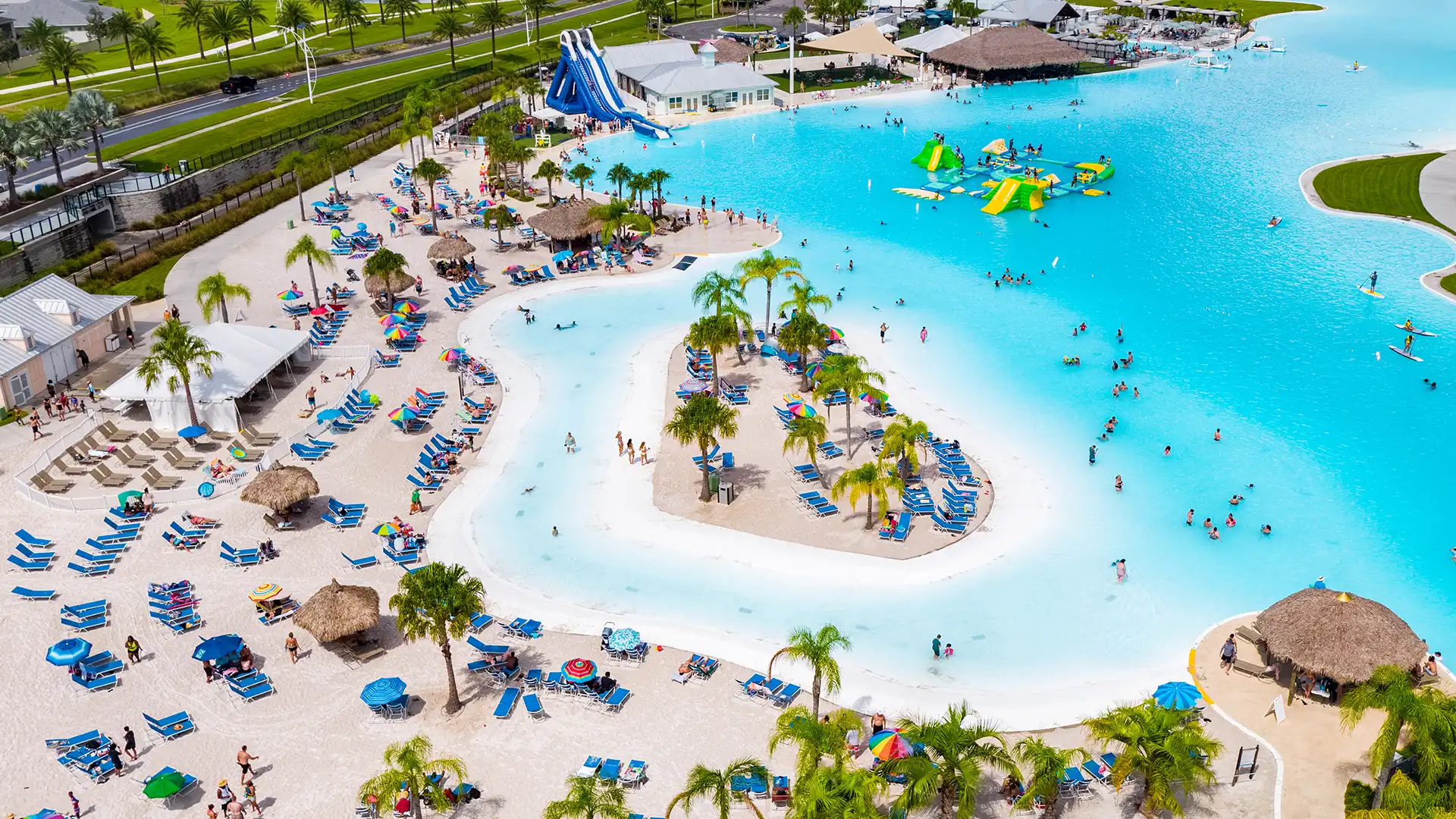 Aurora at Epperson Ranch Lagoon and beach with a crowd of people swimming, lounging, and paddleboarding