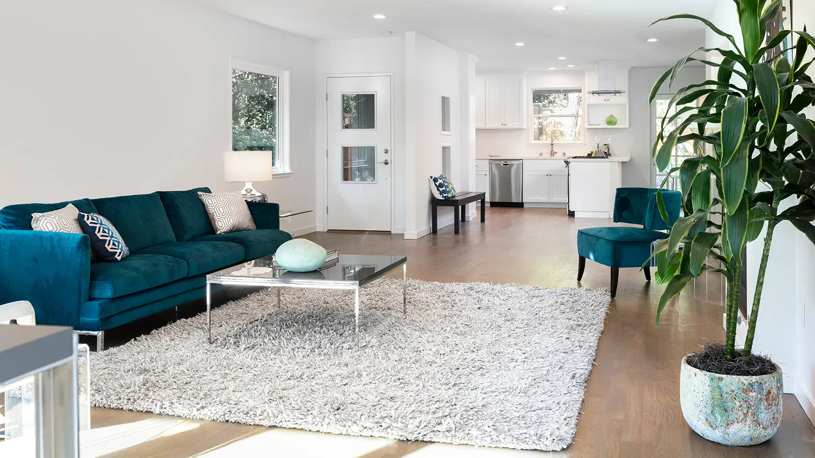 Beautiful and large living room interior with hardwood floors, fluffy rug and designer furniture
